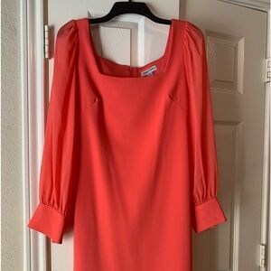 Shelby and Palmer peach color midi dress with sheer sleeves.